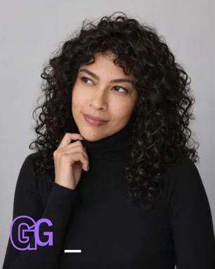 Portrait of Gabriela García in a black turtleneck against a gray background.